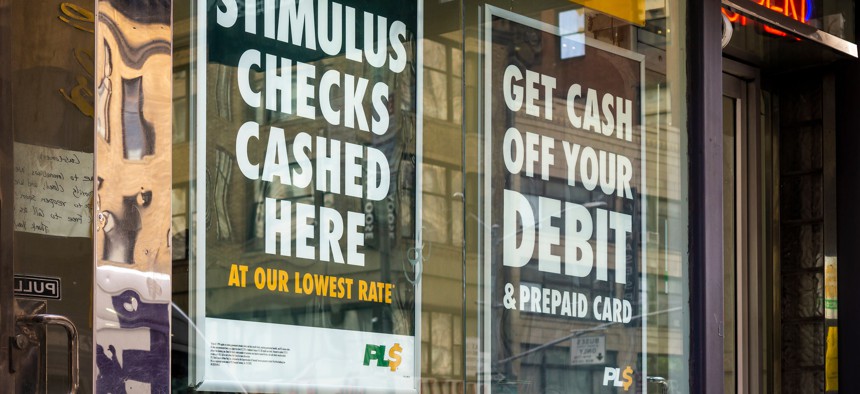 A check cashing business in New York City advertises that they cash stimulus checks in March 2020.