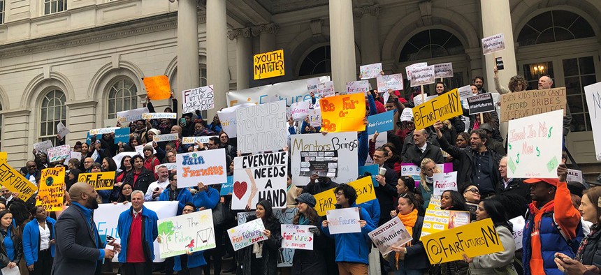 Youth advocates standing on the steps of New York City Hall.