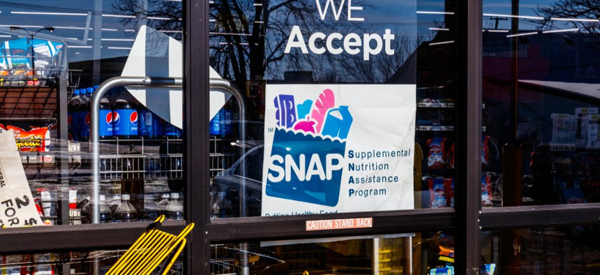 A sign acknowledging SNAP benefits on a storefront window