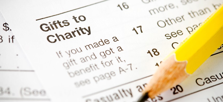 Pencil sits on tax form showing charitable deduction.