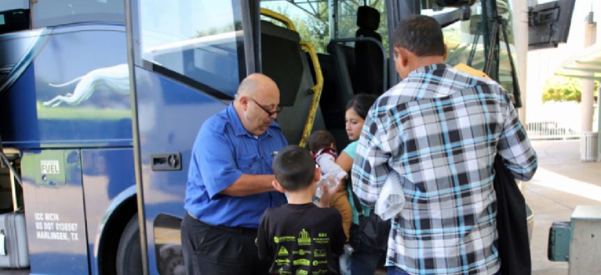 Migrants at a bus