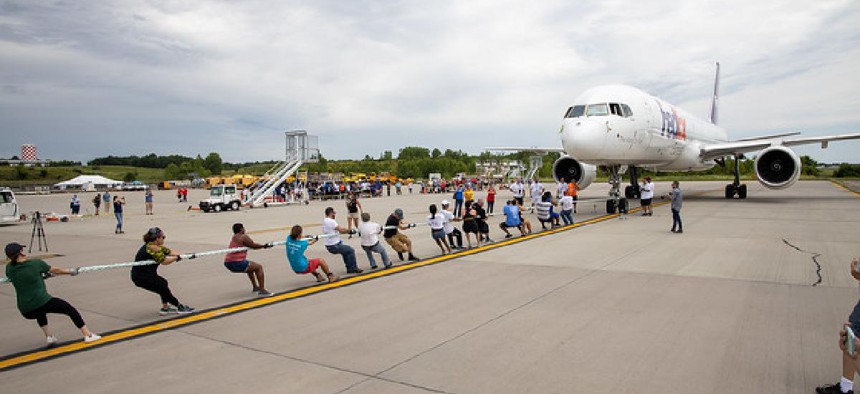 People pull a Boeing 747 at a fundraiser for a New York nonprofit.
