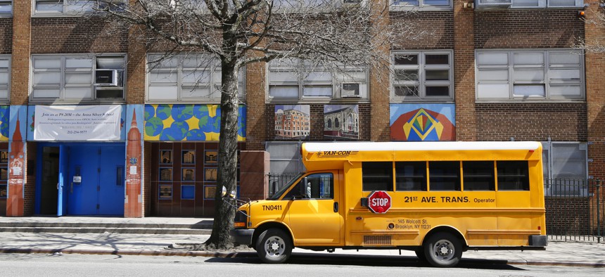 School bus passes public school in New York City. 