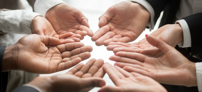 Hands held up together in a circle.