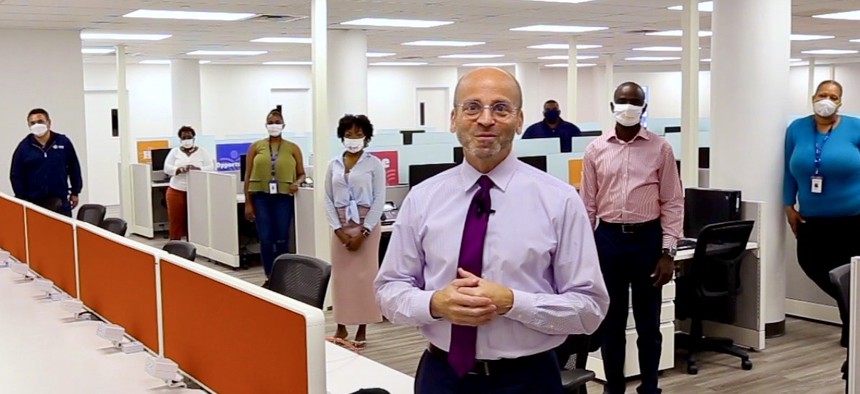 Rising Ground staff and CEO and its office in Brooklyn, standing apart in masks.