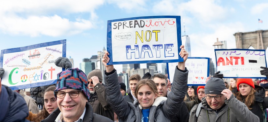 People hold signs protesting hate at No Hate, No Fear Jewish Solidarity March on Jan. 5 in New York.