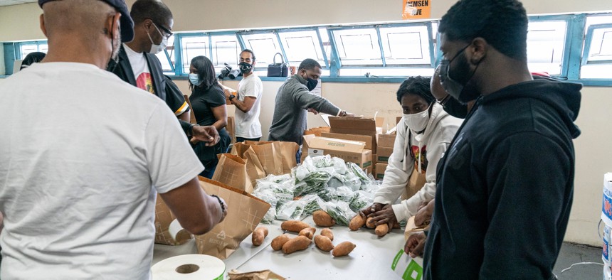 Volunteers and staff pack fresh local food for veterans at HelloFresh Veterans Day Packing Event in Brooklyn.