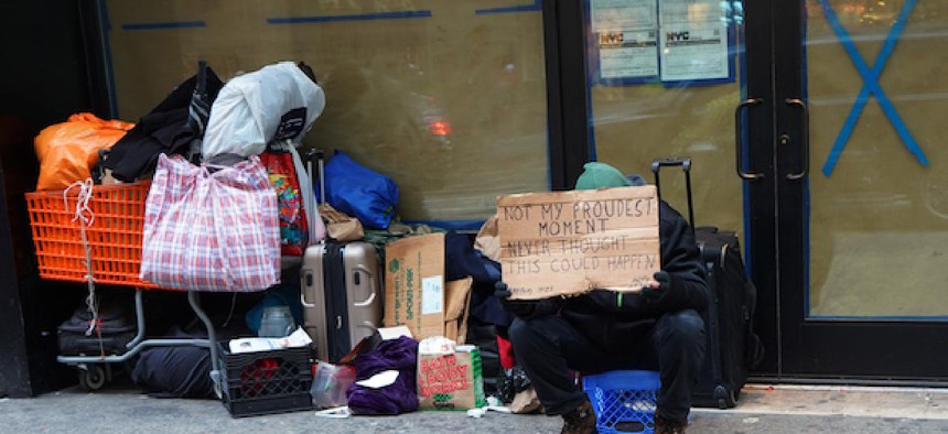 A homeless man sitting in Midtown, Manhattan.