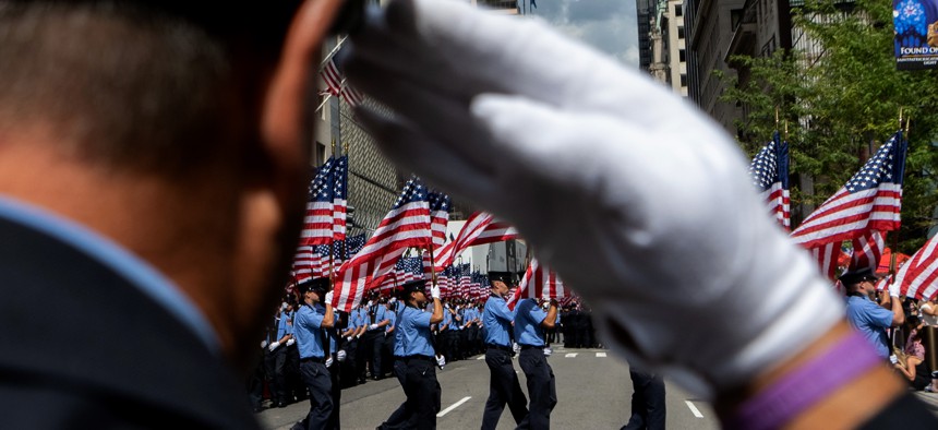 Members of the New York Fire Department carry American flags during the FDNY Memorial Service at St. Patrick's Cathedral on September 11, 2021 in New York City. 