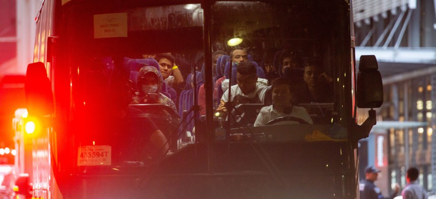  A bus transporting asylum-seekers arrives at the Port Authority bus terminal in New York on Sept. 27. 