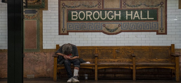 A homeless person sleeps on a subway bench in New York City in September. There are approximately 63,000 homeless people in New York's five boroughs.