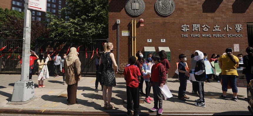 Students and faculty join together in front of Yung Wing School P.S. 124 in New York City. 