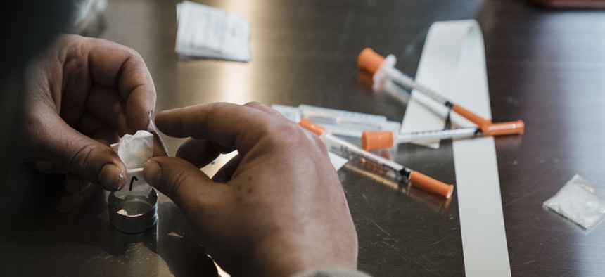 A man utilizes the narcotic consumption booths at a safe injection site at OnPoint NYC. 