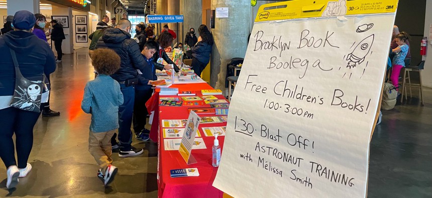 Children and adults check out the Brooklyn Book Bodega at Building 77 in the Brooklyn Navy Yard earlier this month.