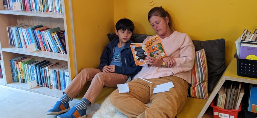 A volunteer tutors a student at Read 718 in Brooklyn