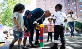New York City Mayor Eric Adams enjoys play time at Union Settlement Union Carver Center in Manhattan last year at the announcement of his administration’s “blueprint” for child care and early childhood education. The city, through a partnership with the Robin Hood Foundation, is now expanding access to its child care voucher program. 