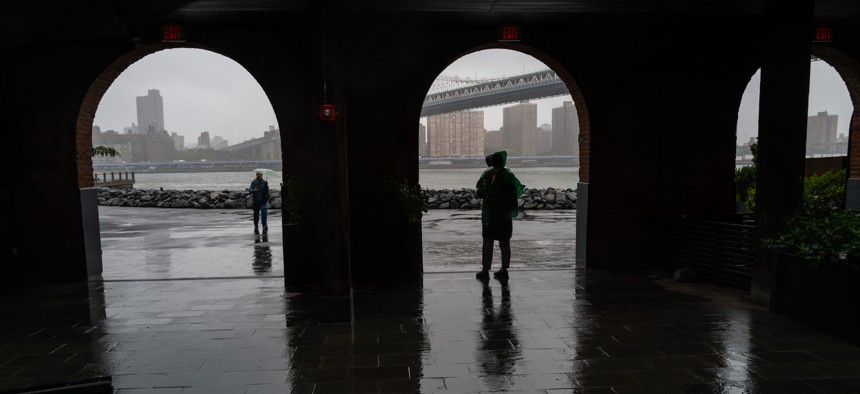 People walk through Brooklyn during heavy rain and high winds as the remnants of Tropical Storm Ophelia continue to move through the area on Mondayh in New York City