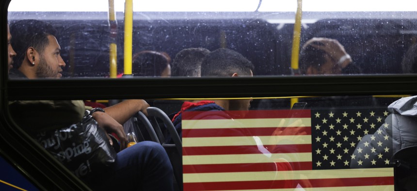 Asylum-seekers board on a bus en route to New York City in 2023.
