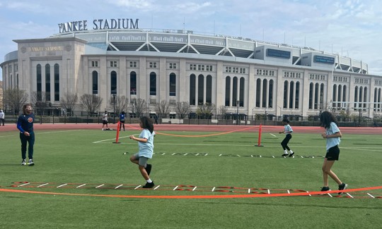Students participate in New York Road Runners programming at Macombs Dam Park outside Yankee Stadium