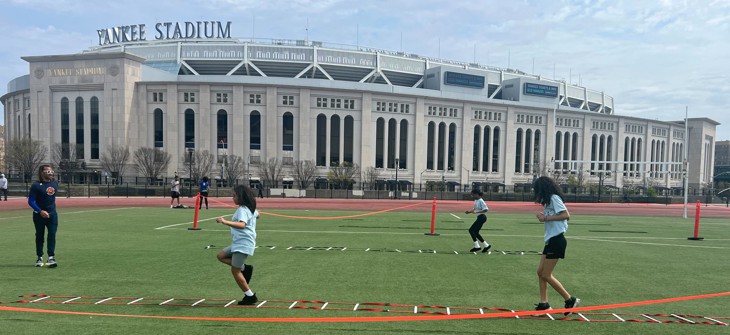 Students participate in New York Road Runners programming at Macombs Dam Park outside Yankee Stadium