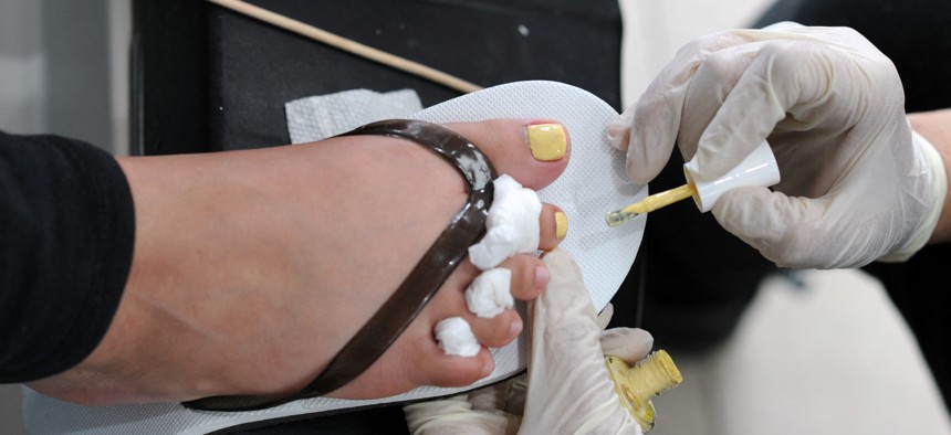 A salon technician gives a pedicure to a client at Mt. Everest Nail Salon in Ridgewood, Queens, New York, on May 11, 2022. 