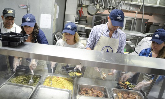  Cameron Adams, cofounder of design software maker Canva, along with actors Patti Murin and Andrew Rannells join in preparing meals for City on Wheels at  at Encore Community Services on September 24, 2015.