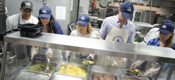  Cameron Adams, cofounder of design software maker Canva, along with actors Patti Murin and Andrew Rannells join in preparing meals for City on Wheels at  at Encore Community Services on September 24, 2015.