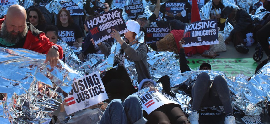 Die-in demonstration by organizers and housing advocates on the steps of the U.S. Supreme Court as oral arguments are heard in Pass v. Johnson on April 22, 2024. 