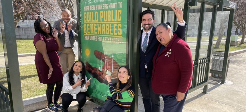 Socialist state legislators pose by a sign promoting the “Build Public Renewables Act.” From left: Assembly Member Phara Souffrant Forrest, state Sen. Jabari Brisport, Assembly Member Sarahana Shrestha, state Sen. Julia Salazar, Assembly Members Zohran Mamdani and Marcela Mitaynes.