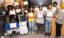 Rowe Scholar participants show off their college financial aid scholarships during the program’s annual College Decision Day.