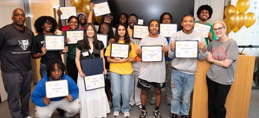 Rowe Scholar participants show off their college financial aid scholarships during the program’s annual College Decision Day.