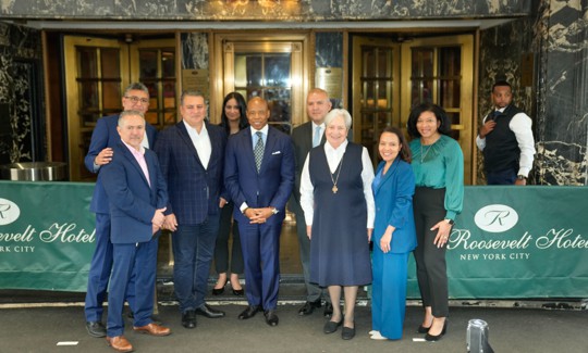 New York City Mayor Eric Adams holds a press conference with Latino leaders outside the Roosevelt Hotel, a hub of migrant services, in May.