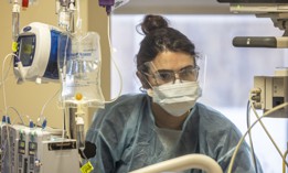 Registered Nurse Bobchak Rylee checks on a patient inside the medical intensive care unit at Long Island Jewish Medical Center in New Hyde Park, New York on January 18, 2022.