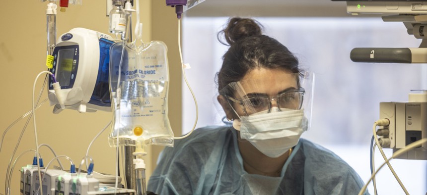 Registered Nurse Bobchak Rylee checks on a patient inside the medical intensive care unit at Long Island Jewish Medical Center in New Hyde Park, New York on January 18, 2022.