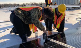 A HOPE program cohort installs solar panelling on a New York City rooftop. 